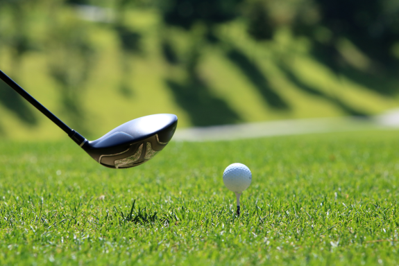 Image of a golf club and golf ball on a tee
