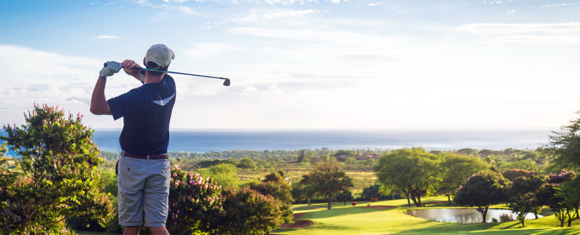 Image of man playing golf on a beautiful golf course with a sea view